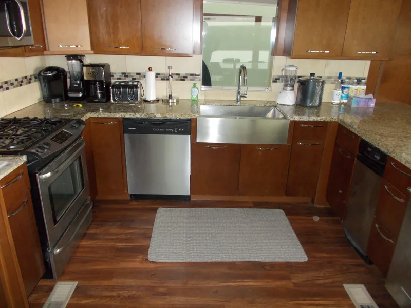 Slide: The Image of Modern kitchen in 2013 Bravada Tranquility Trip 17 with stainless steel appliances and wood cabinets. - 4