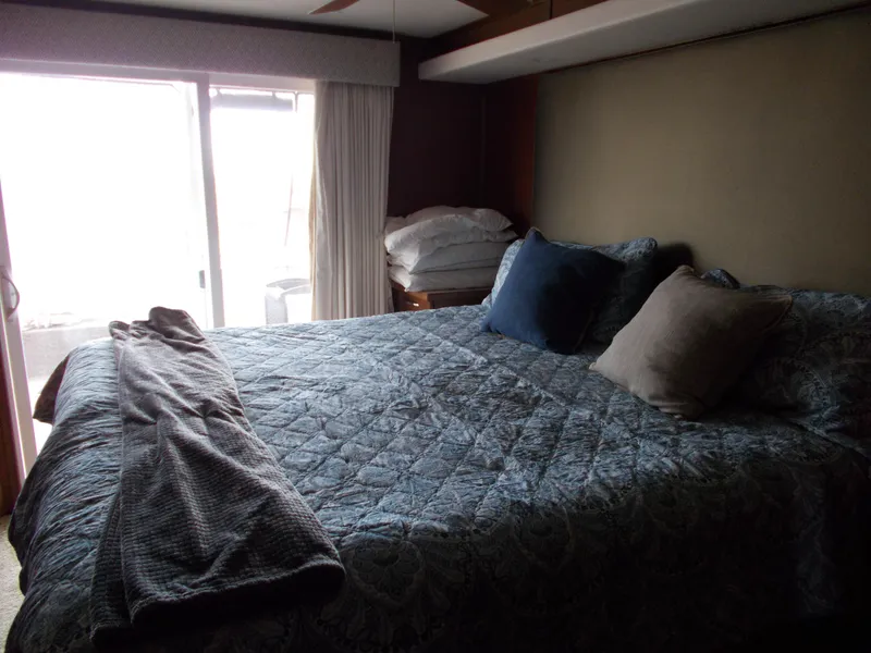 Slide: The Image of Cozy bedroom in 2013 Bravada Tranquility Trip 17 houseboat with large bed and pillows. - 7