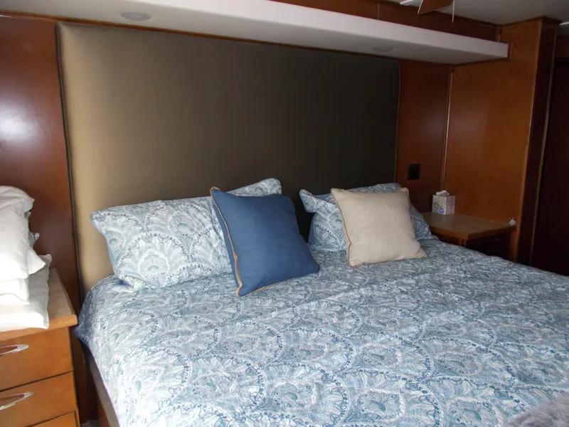 Slide: The Image of Cozy bedroom in 2013 Bravada Tranquility Trip 17 with patterned bedding and wooden accents. - 9
