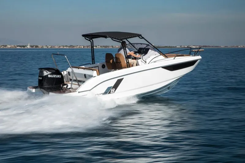 Slide: The Image of 2024 Beneteau Flyer 8 SUNdeck speeding on water with Suzuki outboard motor. - 2
