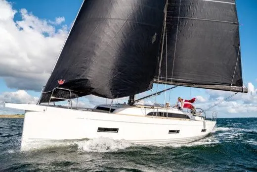 The Image of 2026 X-Yachts X 4.0 sailing on open water with black sails and white hull. - 0