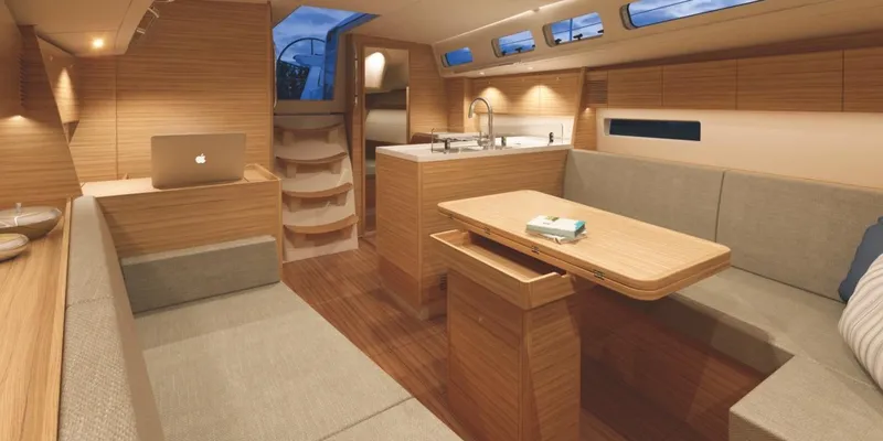 Slide: The Image of Modern interior of 2026 X-Yachts X 4.0 sailboat with sleek wood finishes and cozy seating. - 8
