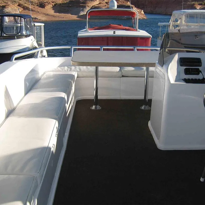 Slide: The Image of Interior of 2011 Bravada Dream Weaver Trip 15 boat with white seating and table. - 12