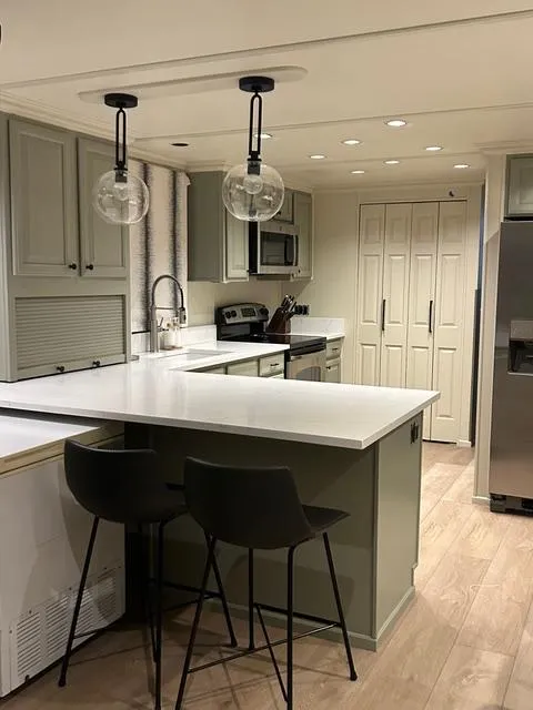 Slide: The Image of Modern kitchen in a 2008 Sumerset Red Rocks Trip 11 houseboat with sleek countertops and pendant lighting. - 19