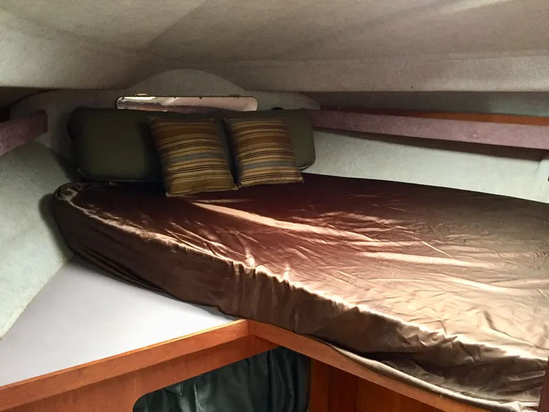 Slide: The Image of Cozy cabin interior of 1986 Cruisers Yachts 336 Ultra Vee with plush bedding and pillows. - 11