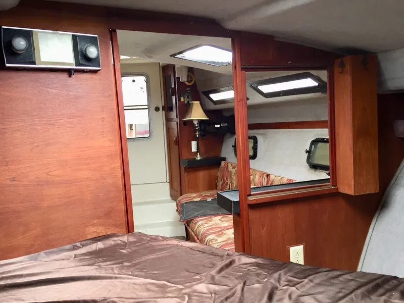 Slide: The Image of Interior of 1986 Cruisers Yachts 336 Ultra Vee with wood paneling and cozy seating area. - 13