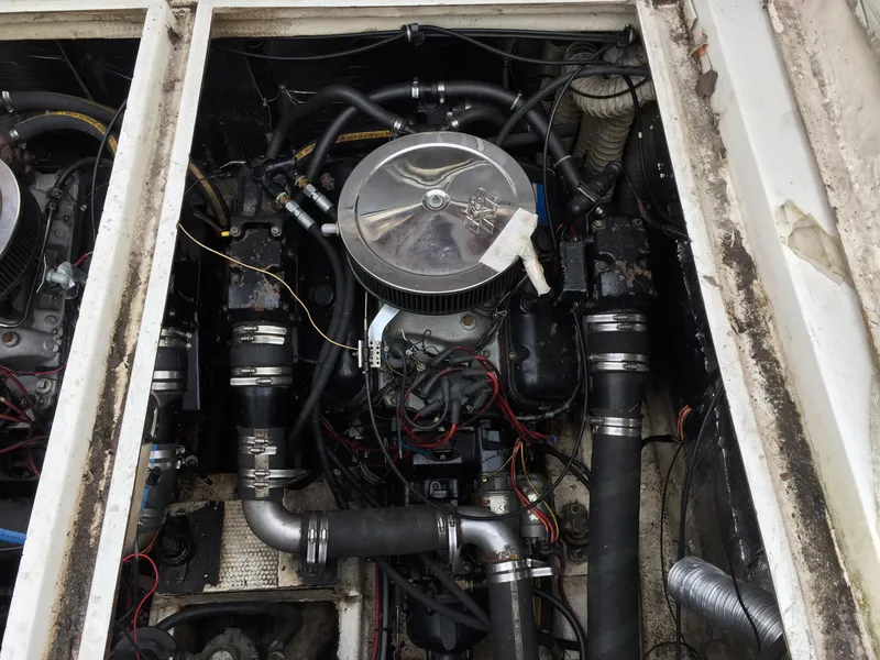 Slide: The Image of Engine compartment of a 1986 Cruisers Yachts 336 Ultra Vee, showing mechanical components and wiring. - 18