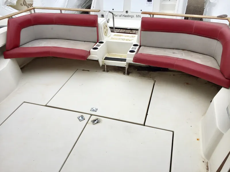Slide: The Image of 1986 Cruisers Yachts 336 Ultra Vee interior with red and gray seating, spacious deck area. - 3