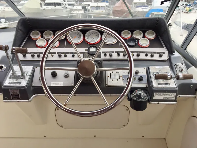 Slide: The Image of 1986 Cruisers Yachts 336 Ultra Vee helm with gauges and steering wheel. - 5