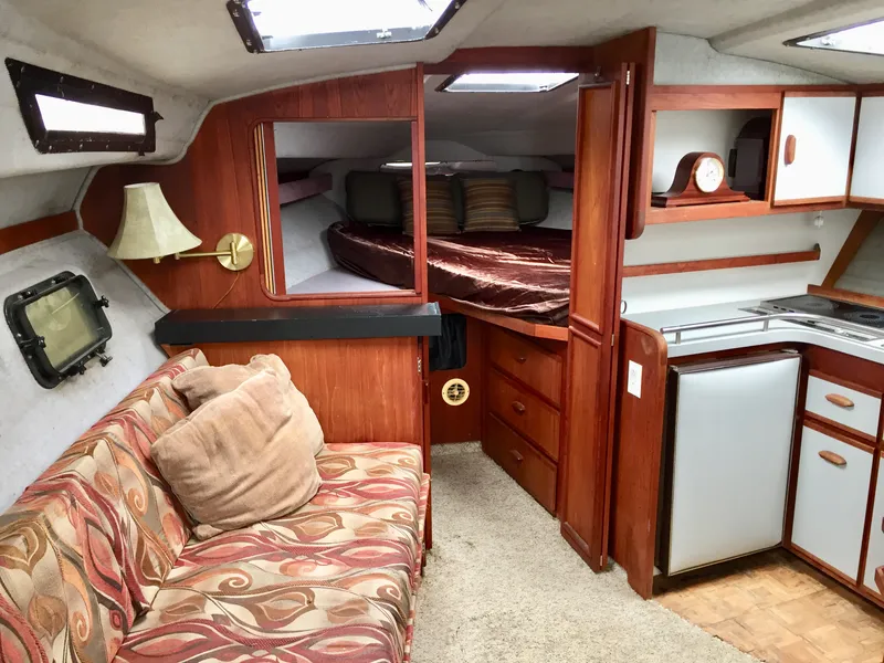 Slide: The Image of Interior of 1986 Cruisers Yachts 336 Ultra Vee with cozy seating and compact kitchen. - 6