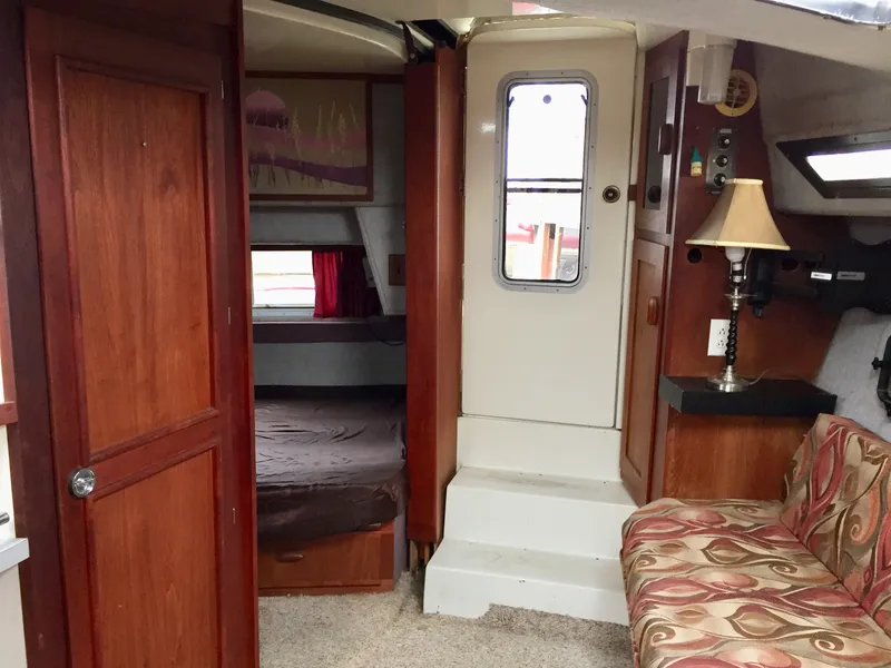 Slide: The Image of Interior of 1986 Cruisers Yachts 336 Ultra Vee with wood paneling and cozy seating. - 7