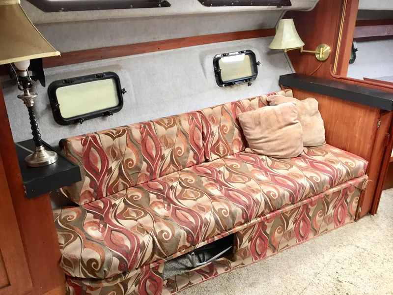 Slide: The Image of 1986 Cruisers Yachts 336 Ultra Vee interior with patterned sofa and nautical decor. - 8