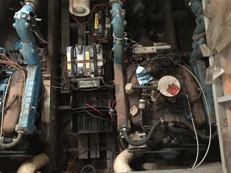 Slide: The Image of Engine compartment of a 1980 Trojan F-30 Flybridge Sedan with visible batteries and wiring. - 11