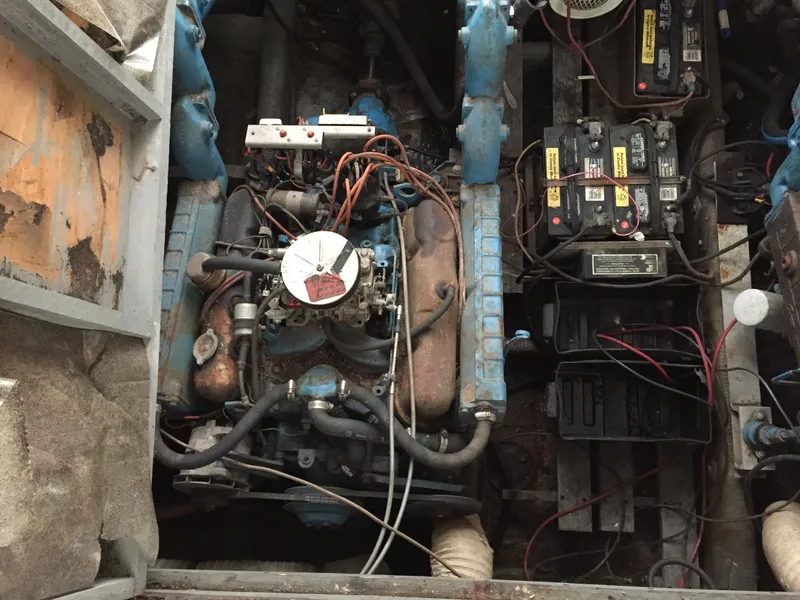 Slide: The Image of Engine compartment of a 1980 Trojan F-30 Flybridge Sedan with visible wiring and batteries. - 12