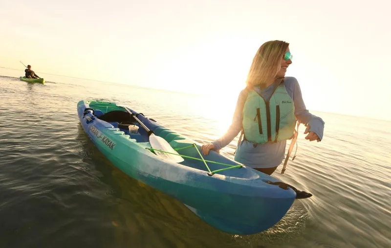 Slide: The Image of Woman with Ocean Kayak Malibu 9.5, 2023 model, enjoying a sunny day on the water. - 3