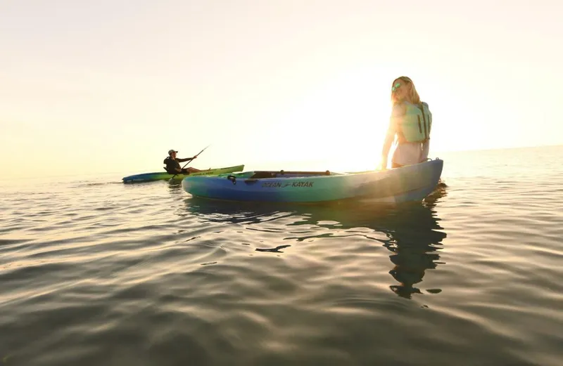 Slide: The Image of Two people kayaking on calm water at sunset, Ocean Kayak Malibu 11.5, 2023. - 11