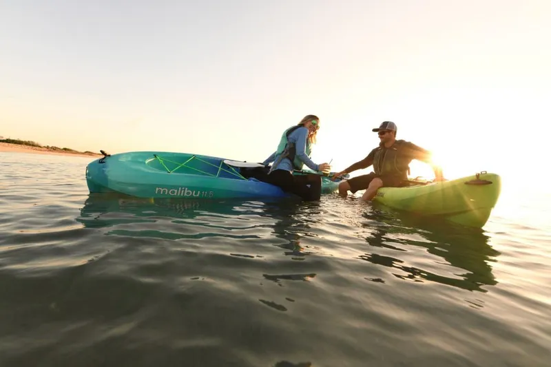 Slide: The Image of Two people kayaking on Ocean Kayak Malibu 11.5 at sunset, 2023 model. - 15