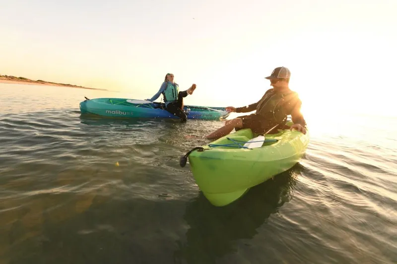 Slide: The Image of Two people kayaking on Ocean Kayak Malibu 11.5 models at sunset, 2023. - 3