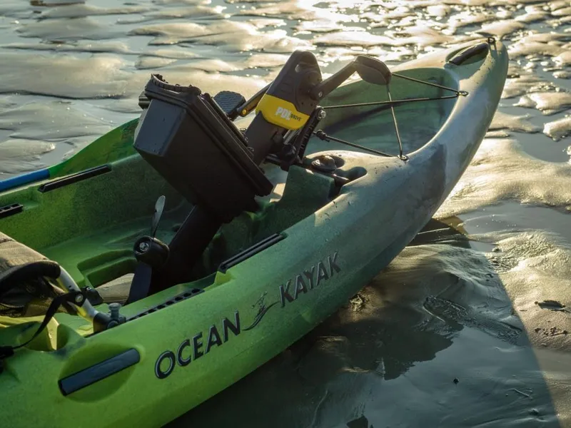 Slide: The Image of 2023 Ocean Kayak Malibu PDL on sandy shore at sunset. - 4
