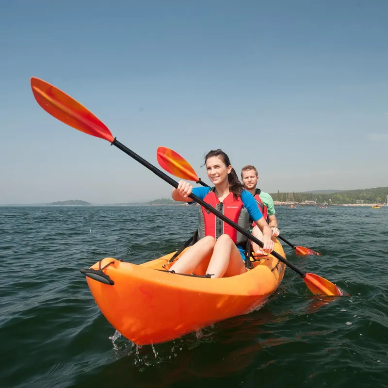 Slide: The Image of Two people kayaking on an Ocean Kayak Malibu Two XL, 2023 model. - 1