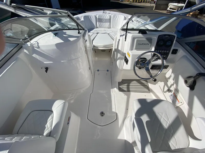 Slide: The Image of 2024 Sea Fox 228 Traveler boat interior with white seating and Garmin navigation system. - 2