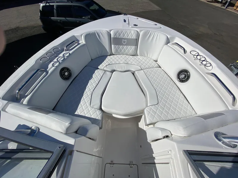 Slide: The Image of 2024 Sea Fox 228 Traveler boat with white cushioned seating and cup holders. - 4