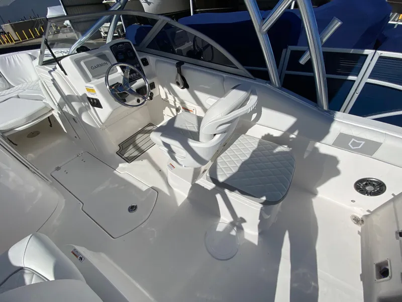Slide: The Image of 2024 Sea Fox 228 Traveler boat interior with steering console and seating. - 5