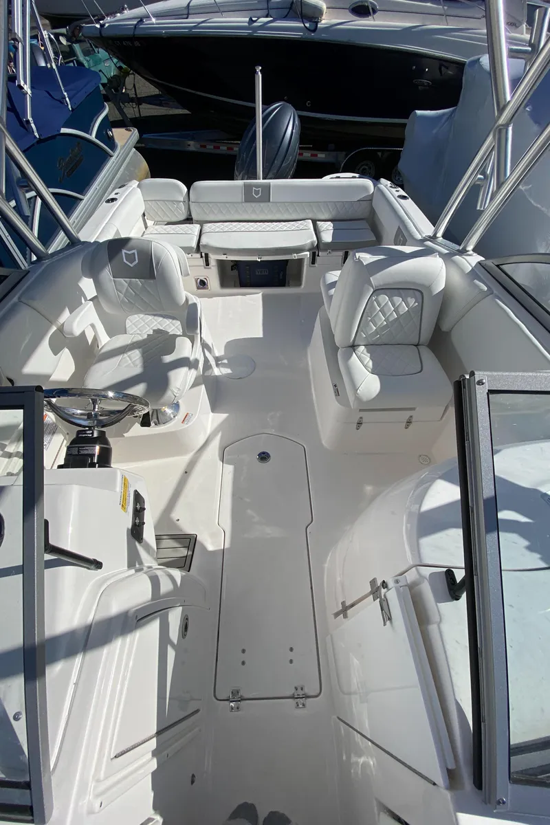 Slide: The Image of 2024 Sea Fox 228 Traveler boat interior with seating and steering console. - 7