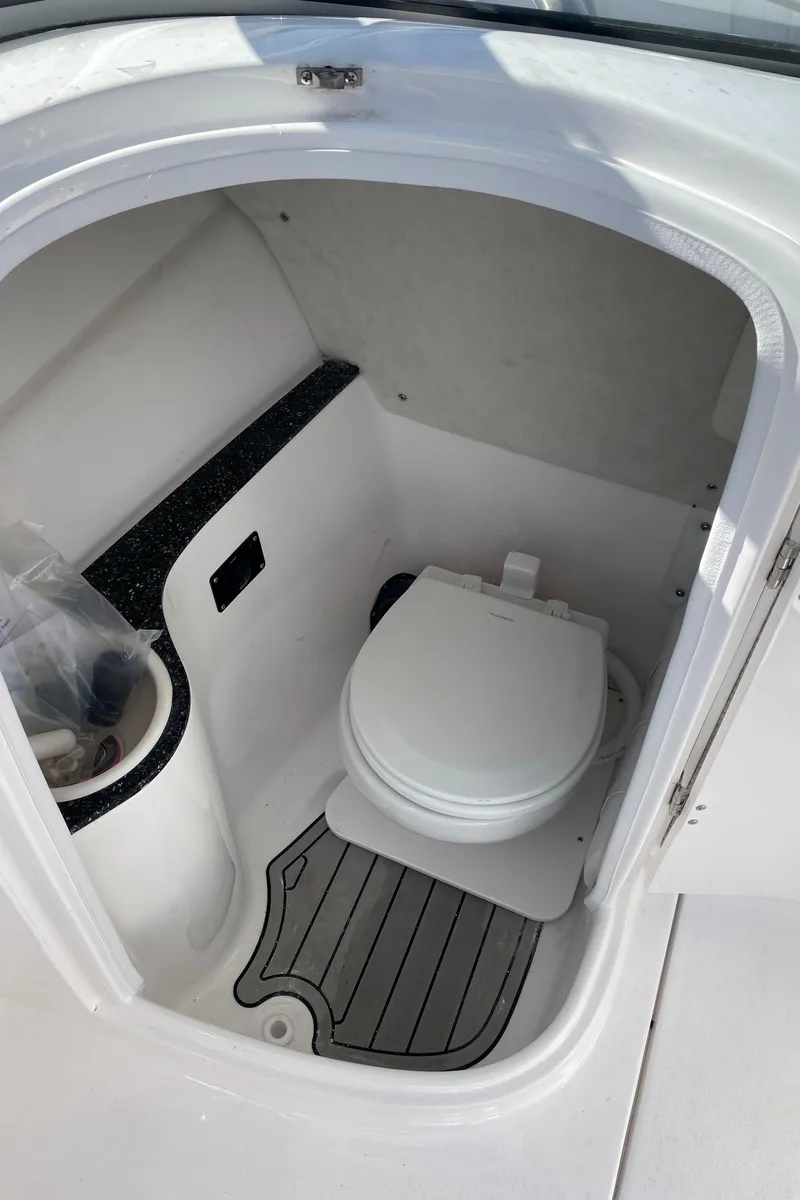 Slide: The Image of 2024 Sea Fox 228 Traveler boat interior with compact marine toilet. - 8