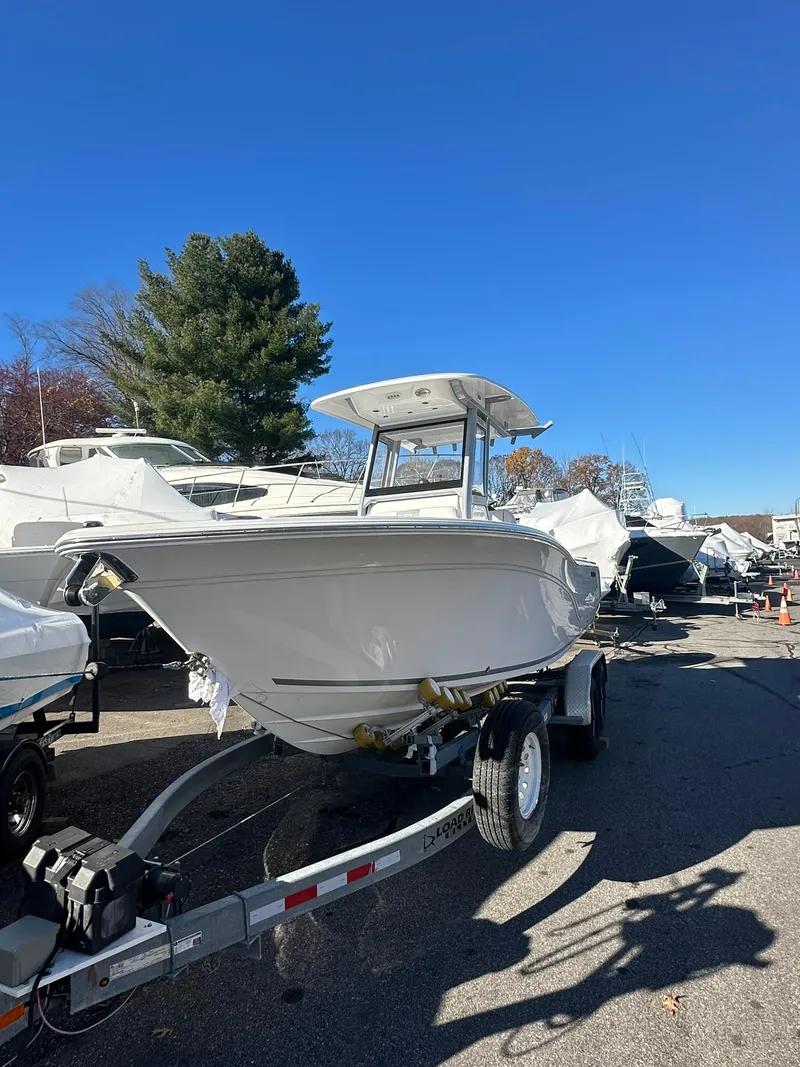 Slide: The Image of 2025 Sea Fox 248 Commander boat on trailer under clear blue sky. - 1