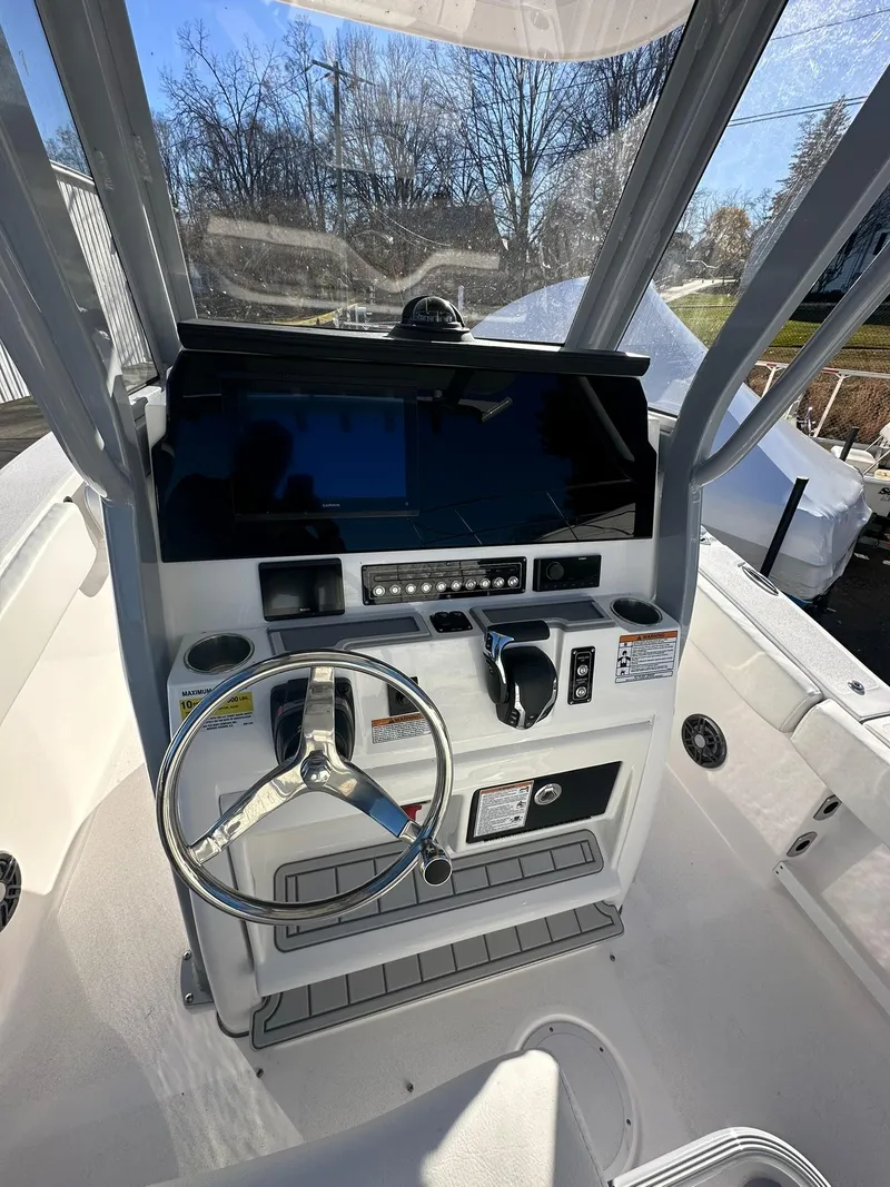 Slide: The Image of 2025 Sea Fox 248 Commander boat console with steering wheel and controls. - 13