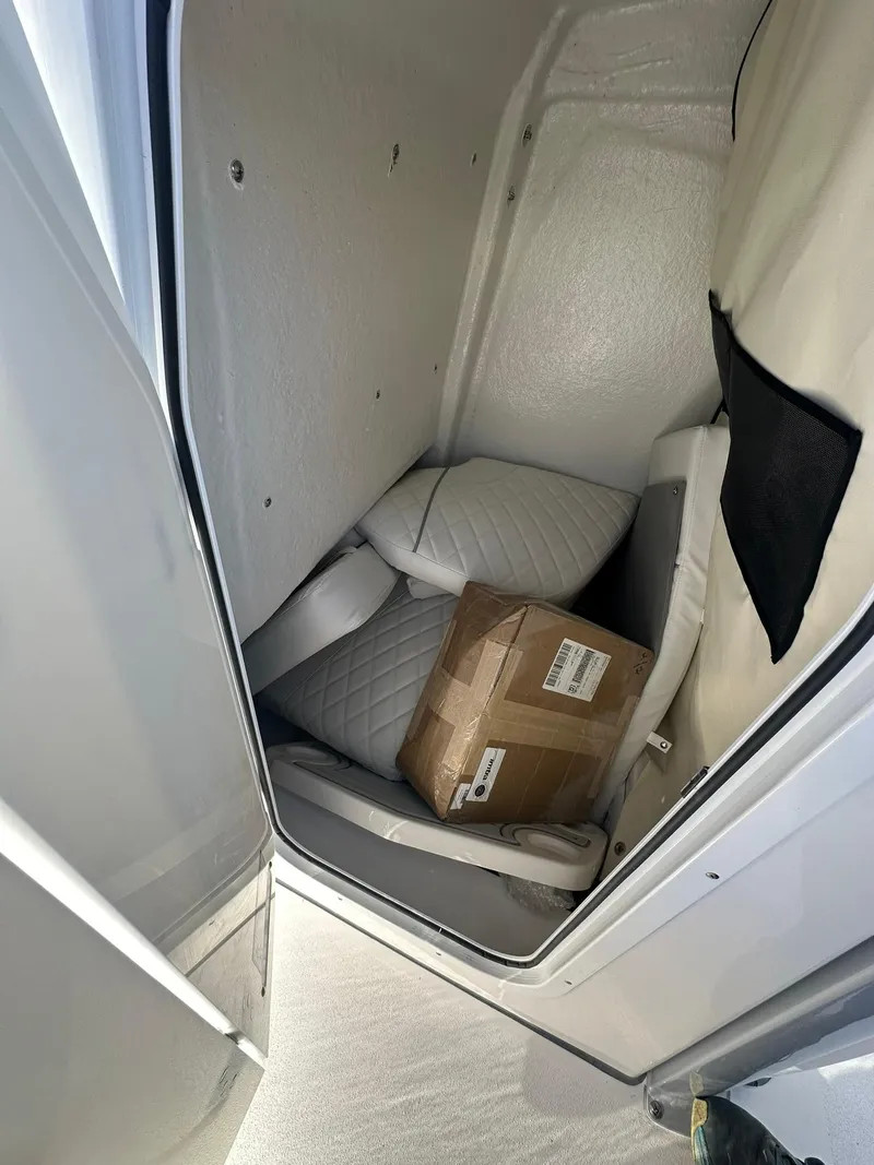 Slide: The Image of Interior storage of 2025 Sea Fox 248 Commander boat with cushions and a cardboard box. - 16