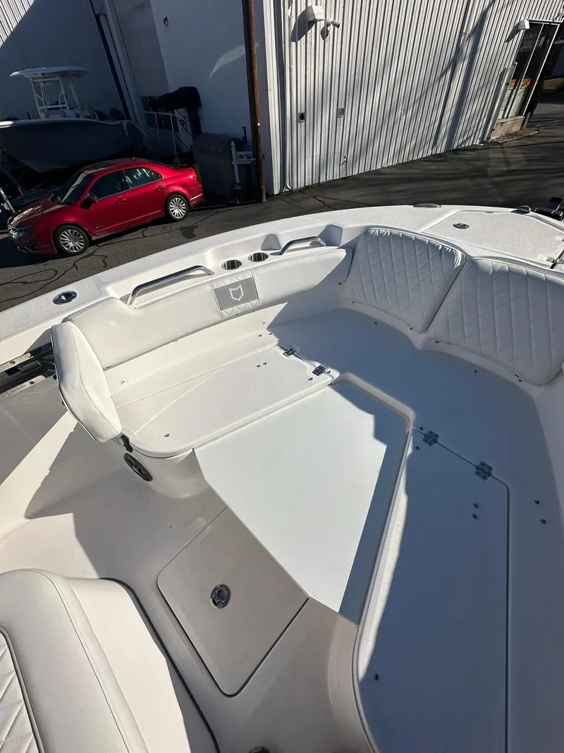 Slide: The Image of 2025 Sea Fox 248 Commander boat interior with white seating and storage compartments. - 18