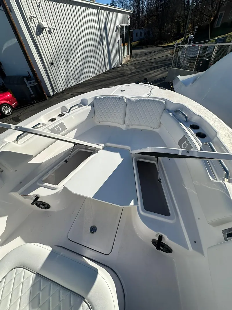 Slide: The Image of 2025 Sea Fox 248 Commander boat interior with white seating and storage compartments. - 19