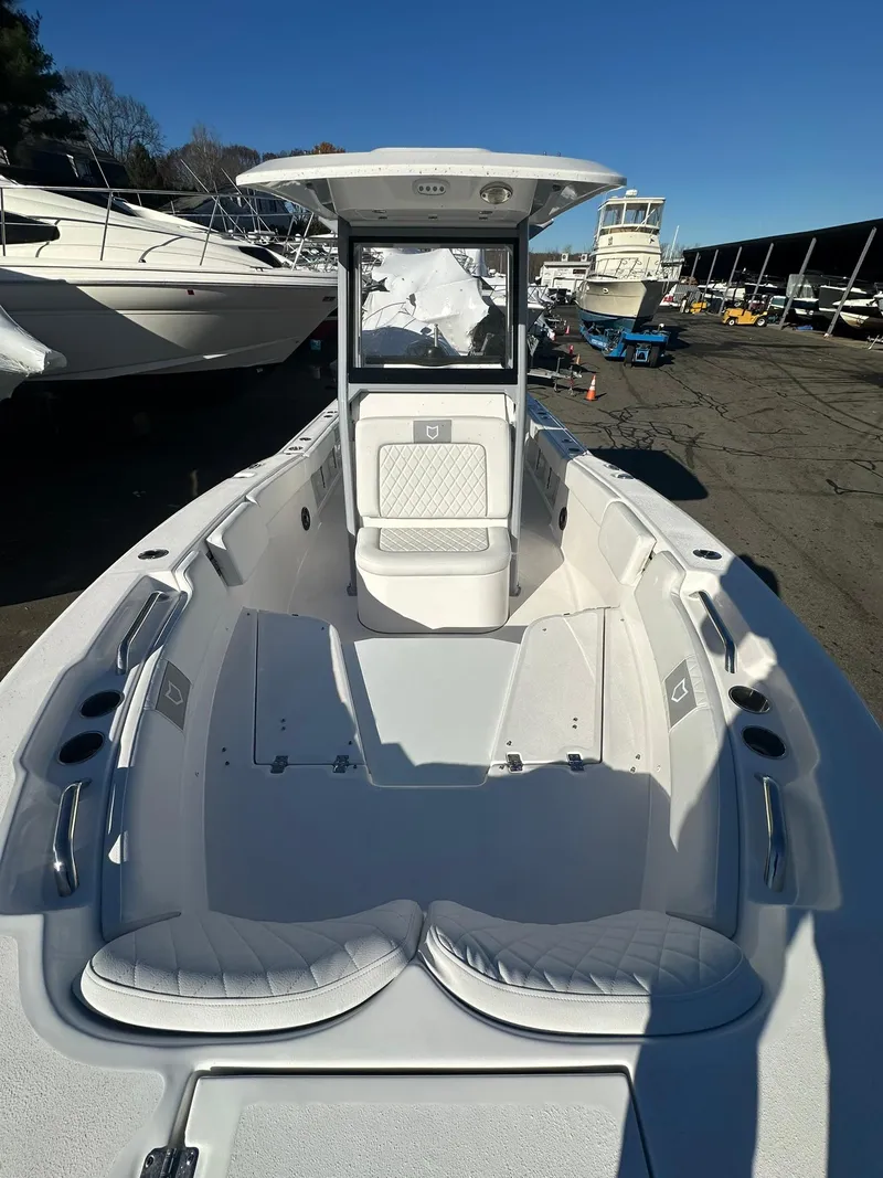 Slide: The Image of 2025 Sea Fox 248 Commander boat, spacious deck, sleek design, docked in marina. - 22