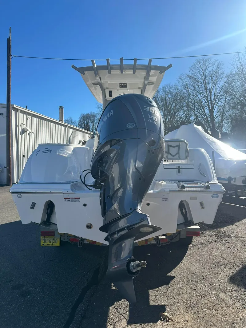 Slide: The Image of 2025 Sea Fox 248 Commander boat with Yamaha outboard motor, parked outdoors. - 5