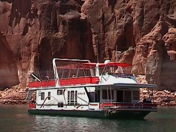 Slide: The Image of Houseboat Sharpe Just Because Trip 33, 2002, on scenic lake with rocky cliffs. - 2