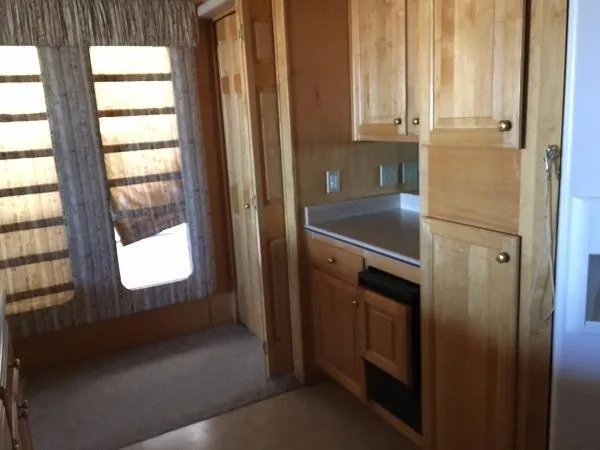 Slide: The Image of Compact kitchen area in 2002 Sharpe Just Because Trip 33 houseboat. - 21