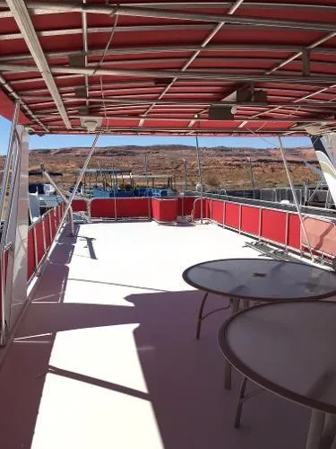 Slide: The Image of Upper deck of 2002 Sharpe Just Because Trip 33 houseboat with red canopy and tables. - 27