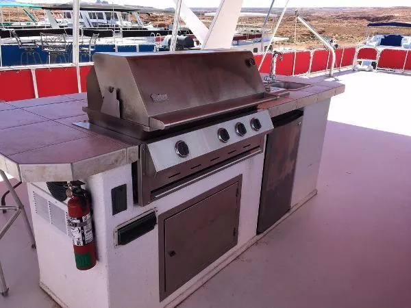 Slide: The Image of Outdoor kitchen on Sharpe Just Because Trip 33 houseboat, featuring a stainless steel grill. - 29