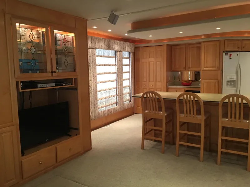 Slide: The Image of Spacious kitchen and living area in 2002 Sharpe Just Because Trip 33 houseboat. - 4