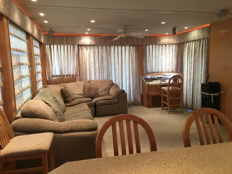 Slide: The Image of Cozy living area in 2002 Sharpe Just Because Trip 33 houseboat with sofa and dining space. - 5