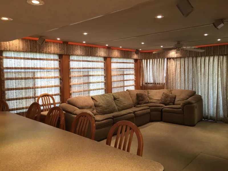 Slide: The Image of Spacious living area in 2002 Sharpe Just Because Trip 33 houseboat with cozy seating. - 6