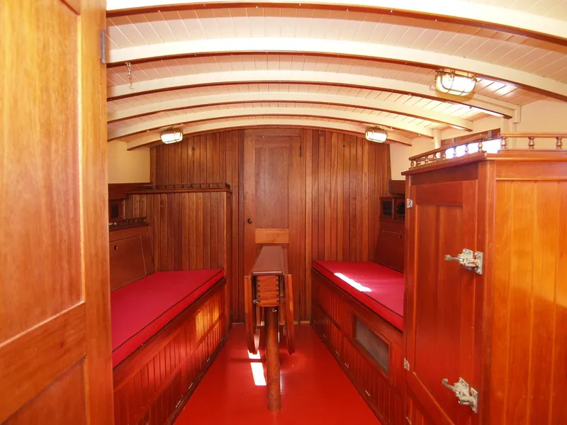 Slide: The Image of Interior of 1933 Frank M Weeks Cruiser with wooden paneling and red cushions. - 10