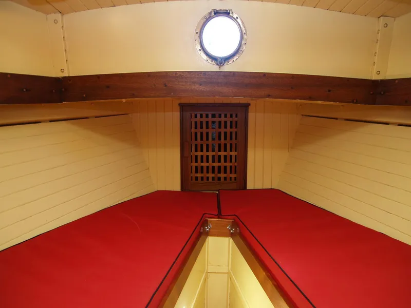 Slide: The Image of Interior of 1933 Historic Frank M Weeks Cruiser with red cushions and wooden accents. - 13