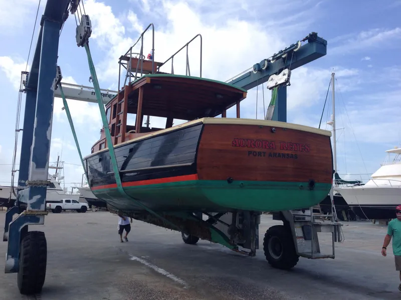 Slide: The Image of Historic 1933 Frank M Weeks Cruiser being lifted at a marina. - 19
