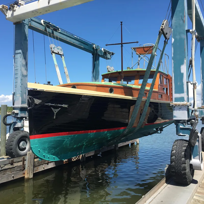 Slide: The Image of Historic 1933 Frank M Weeks Cruiser being lifted from water by crane. - 23