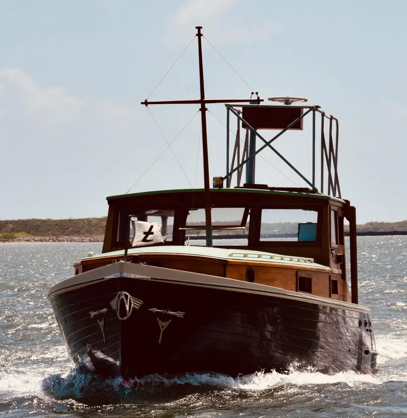 Slide: The Image of Historic 1933 Frank M Weeks Cruiser sailing on open water under clear skies. - 3