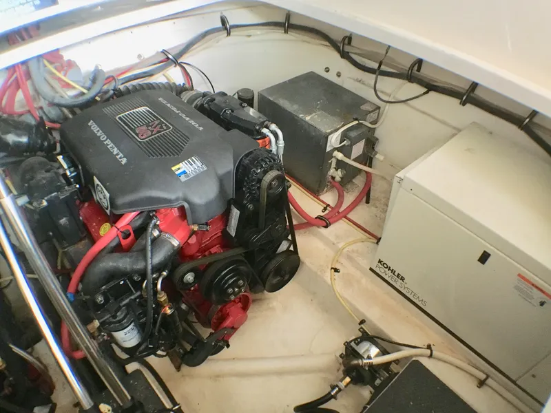 Slide: The Image of The engine room of a 2003 Chaparral Signature 320 features a Volvo Penta engine and electrical components. - 20