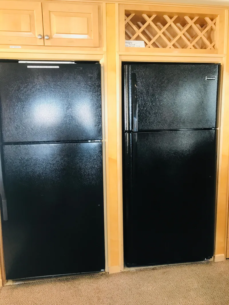 Slide: The Image of Two black refrigerators in a wooden kitchen setting, 2005 Stardust Cruisers model. - 10